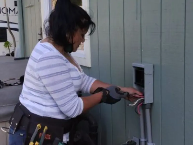 Licensed electrician wiring an exterior subpanel in Mount Zion